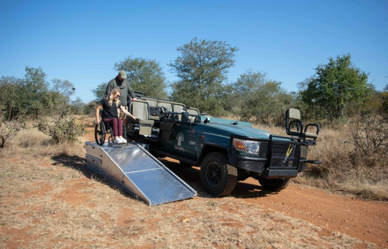 “Wheelchair-accessible safari vehicle with a mobile ramp at Ximuwu, facilitating inclusive participation in bush breakfasts, dinners, and scenic drink stops.”